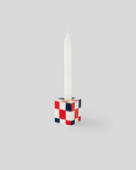 Navy and Poppy and Cream Checker Small Candlestick Holder with a white candle in it
