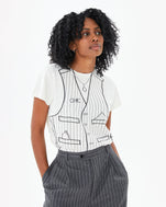 Mecca wearing the Cream Trompe l’oeil Vest Classic Tee tucked in to suit pants