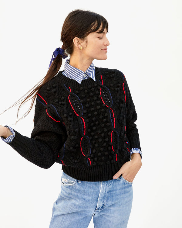 danica looking off to the side while wearing the Black with red and navy chains Drop Shoulder Sweater