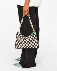 Model holding Shortie Strap on Flat Clutch