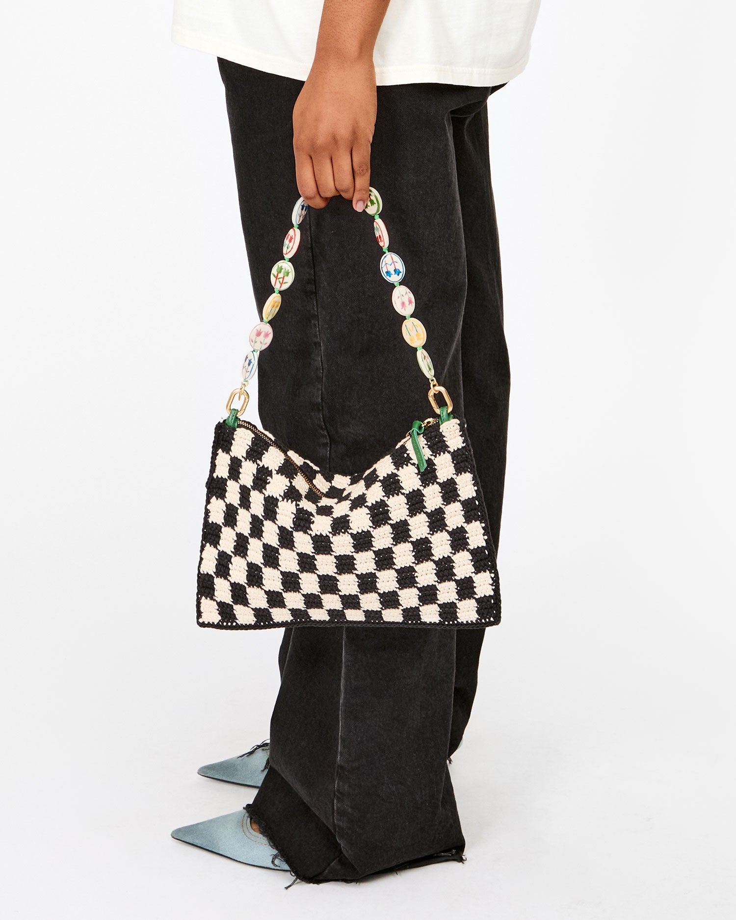 Model holding Shortie Strap on Flat Clutch