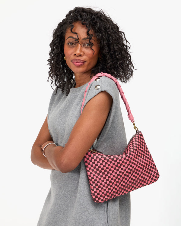 Mecca carries the Flat Clutch with braided shoulder strap on her shoulder