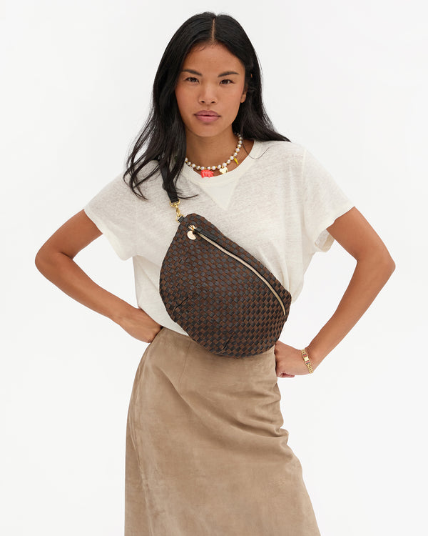 Model carrying the Black/Chocolate Woven Grande Fanny across her chest.