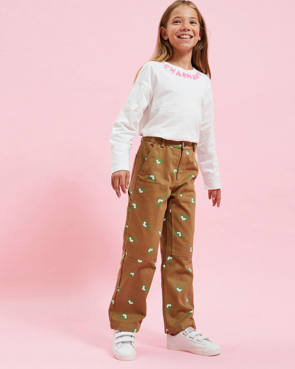 Model wearing the Cream w/ Dusty Pink Charmant Kids Boxy Longsleeve Tee with the Khaki Kids Pants
