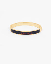 Le Bangle Bracelet featuring a black enamel inlay with the word 'TRAGEDIE' in red lettering.
