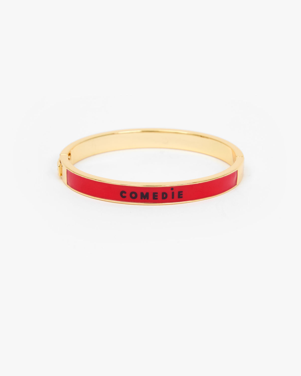 Le Bangle Bracelet with a vibrant red enamel inlay and the word 'COMEDIE' printed in black on the front.