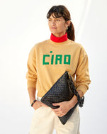 danica wearing the oat le drop with a red turtleneck underneath