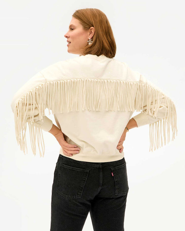 back view of sonnie in the Cream Le Drop Fringe and black jeans