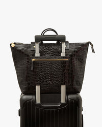 Le Zip Sac with Travel Pocket shown on roller suitcase handle