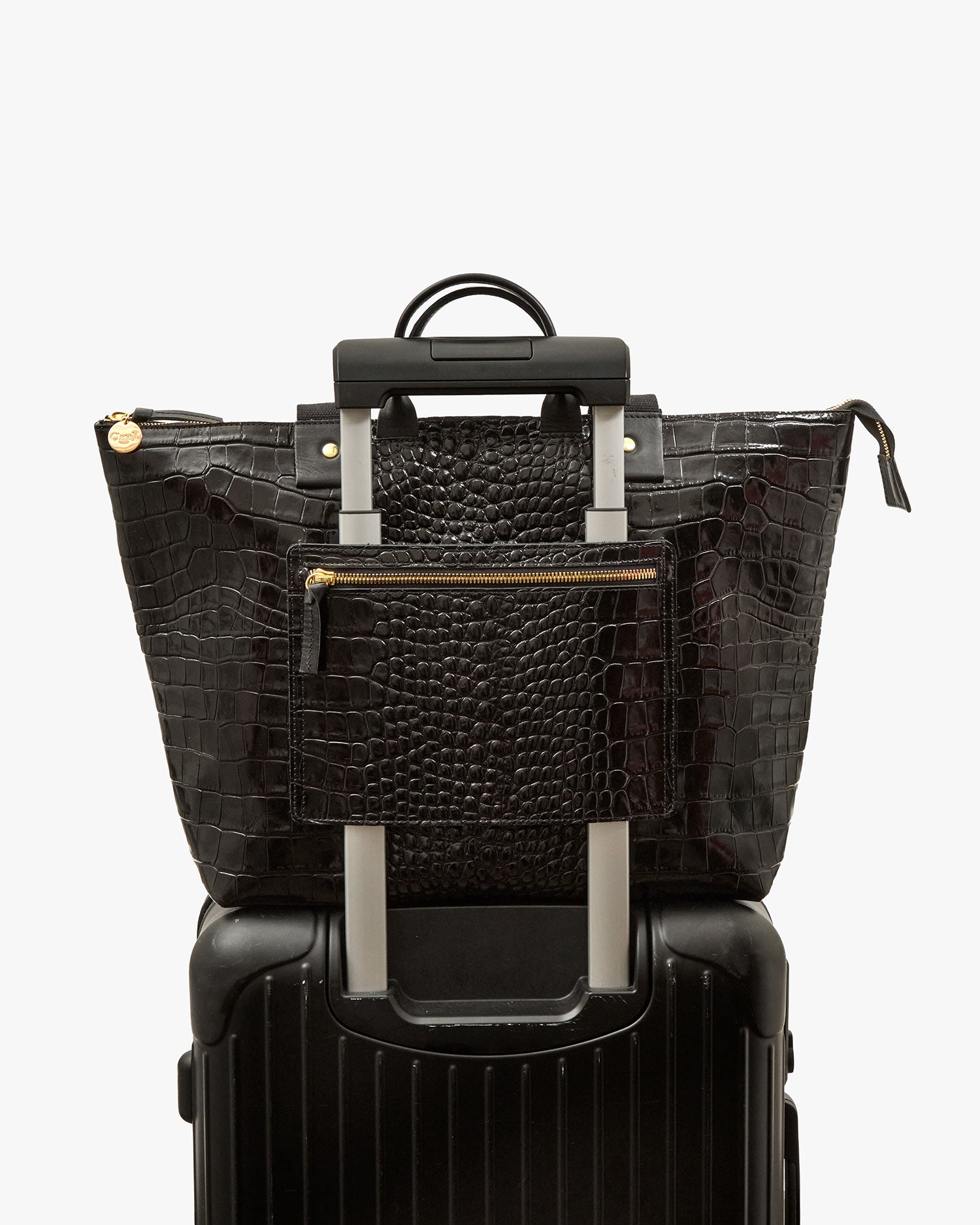 Le Zip Sac with Travel Pocket shown on roller suitcase handle