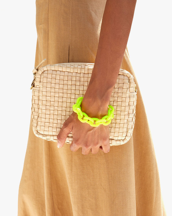 Hayley wearing the Neon Yellow Resin Link Bracelet and Holding the Cream Woven Checker Midi Sac as a Clutch