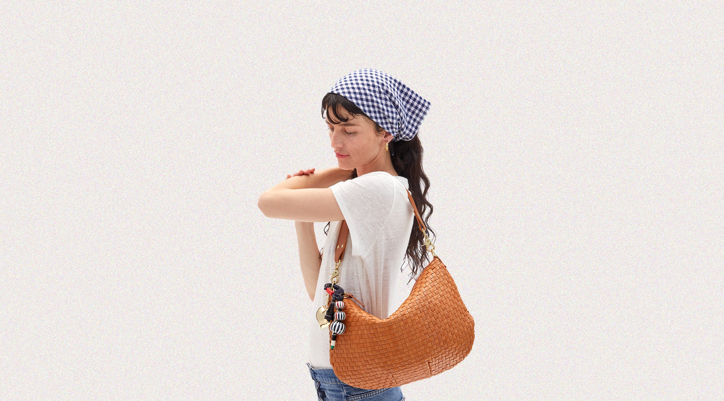 Model carrying the Natural Woven Moyen Messenger with Fobs attached.