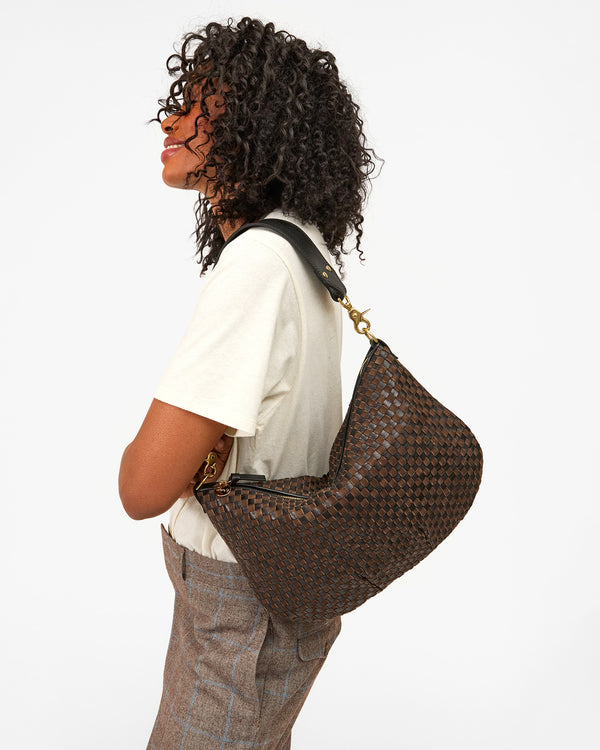 Model carryng Black/Chocolate Woven Moyen Messenger as a shoulder bag.