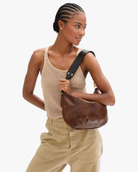 Close up view of Vitoria with Moyen Messenger in Auburn Embossed Python worn on her shoulder