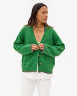 Maly wearing the Oscar Sweater in Granny Smith with an all white outfit
