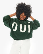 Candice wearing the Forest Grand Oui Oversized Sweatshirt with white jeans