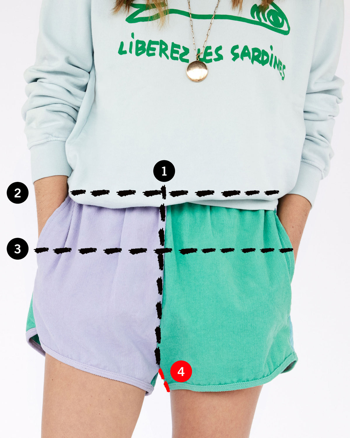 image of Frannie in a lavender and turquoise shorts with 4 lines depicting where the user should measure for their rise, waist, hip and inseam measurements in comparison to the garment