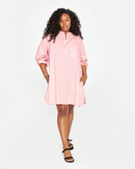 Candice wearing the Flamingo & Cream Stripe St Martin Dress with black sandals