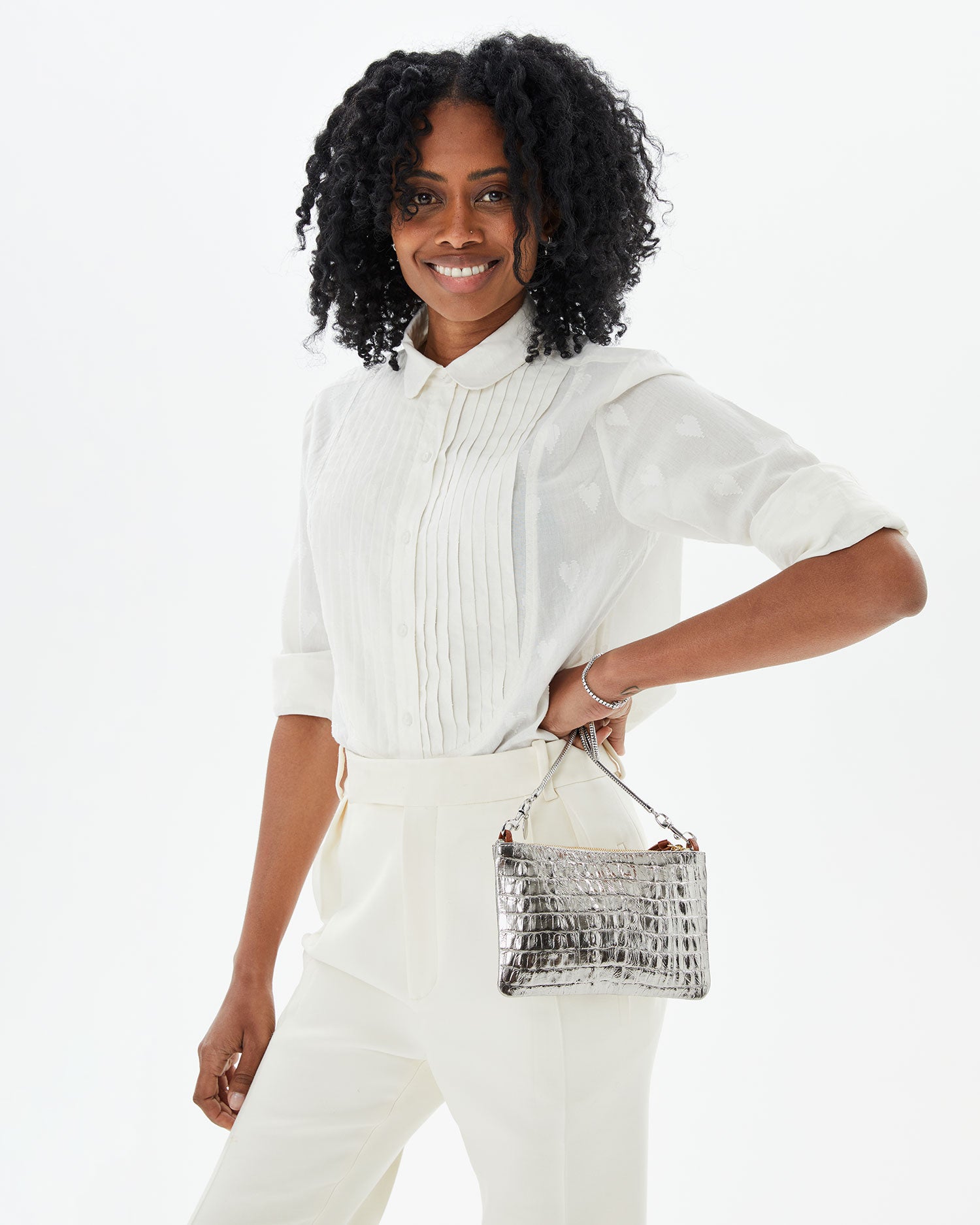 Mecca in an all white outfit with her hand on her hip with the Silver Metallic Croco Wallet Clutch w/ Tabs 