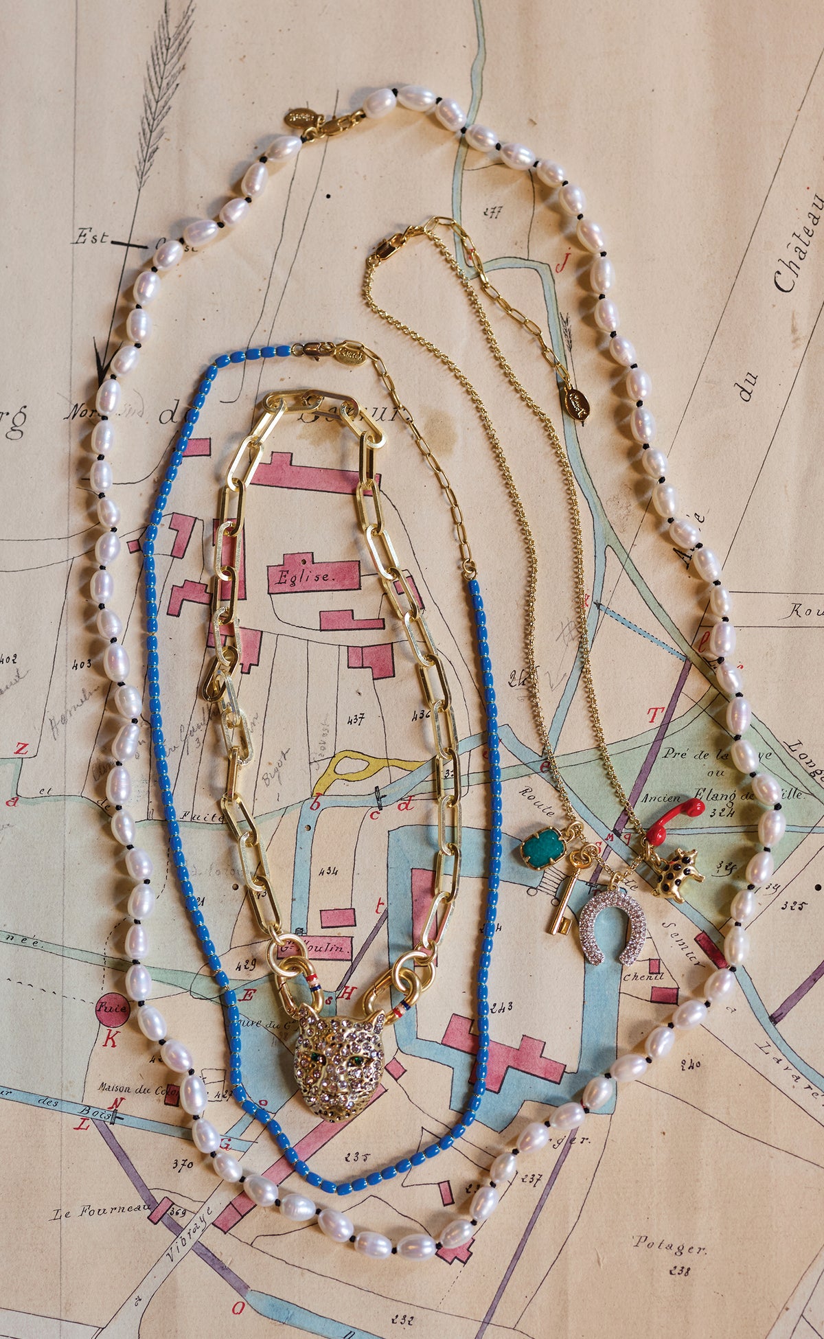 Assortment of four Clare V. Necklaces. 
