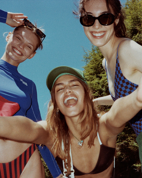 Three models wearing CV x LOF and taking a picture together.