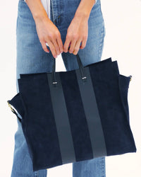 Model carrying the Navy with Racing Stripes Simple Tote.