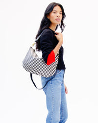 Model carrying the Black and Cream Checker Moyen Messenger.
