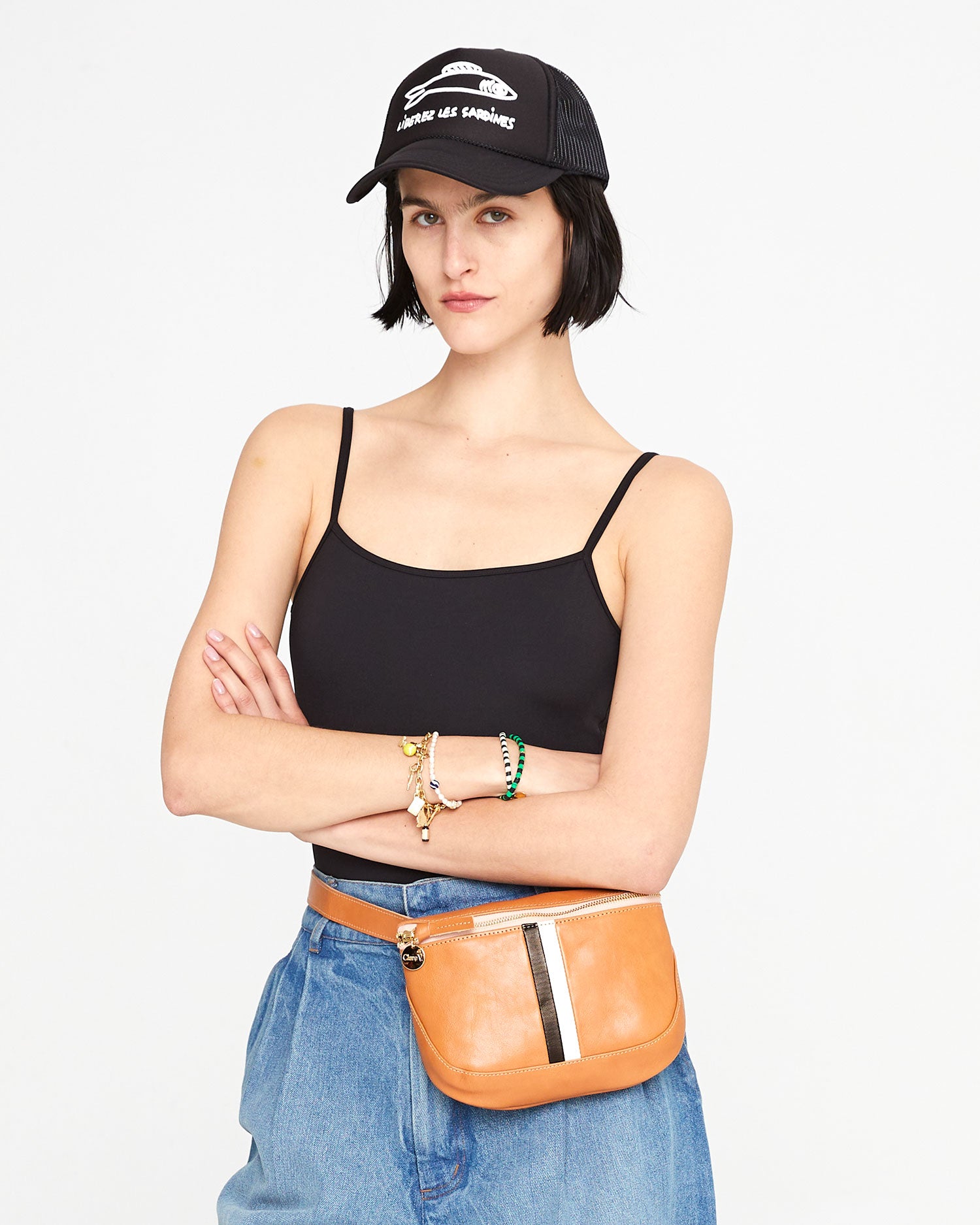 athena wearing the Black with Liberez les Sardines Trucker hat with the natural fanny pack