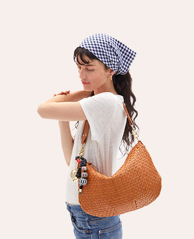 Model carrying the Natural Woven Moyen Messenger with Charms attached. 