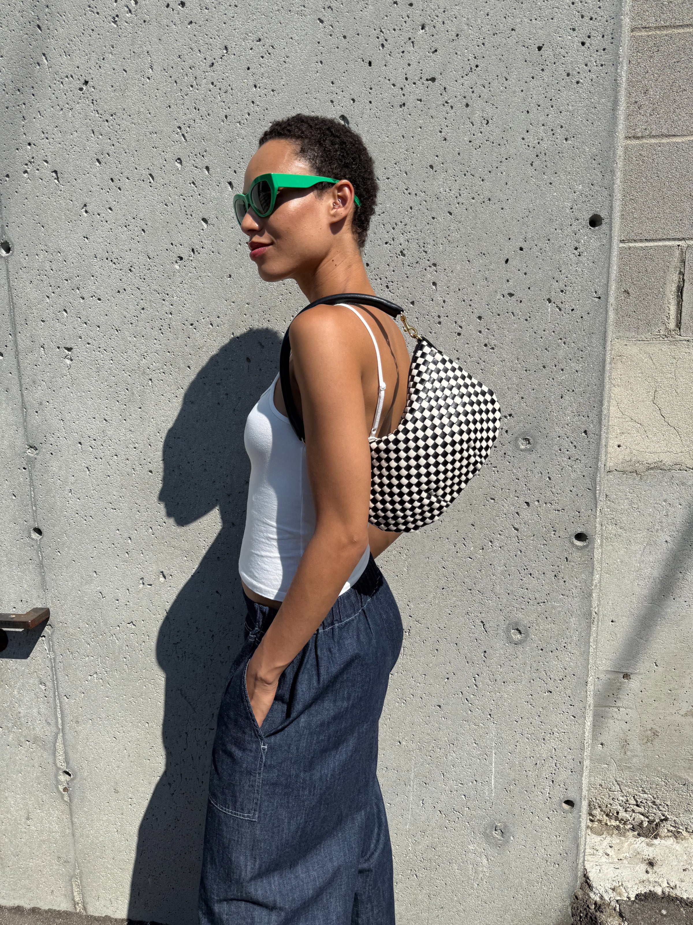 Model carrying the Black/Cream Woven Petit Moyen. 