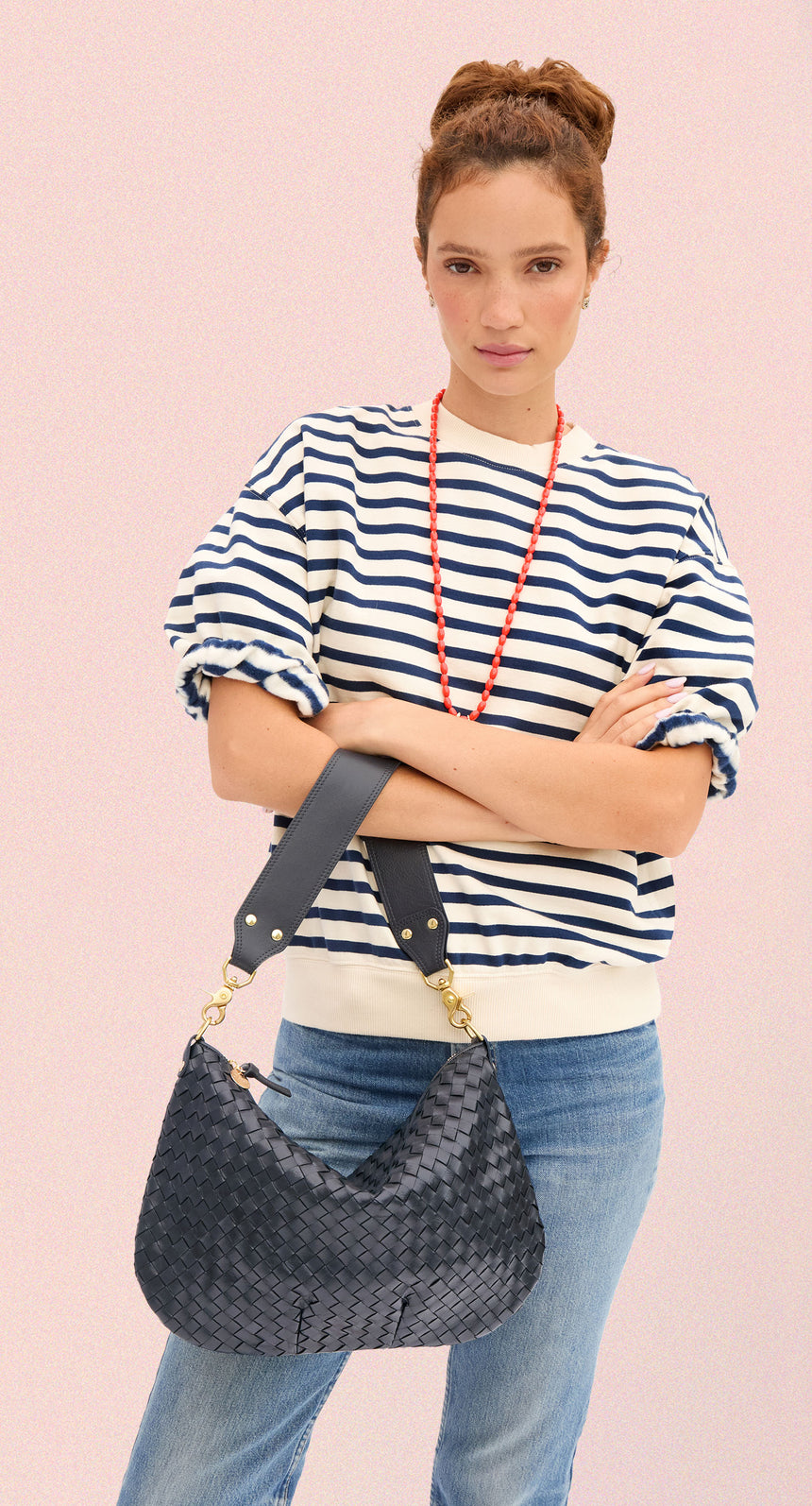 Model carrying the Twilight Navy Diagonal Woven Moyen Messenger.
