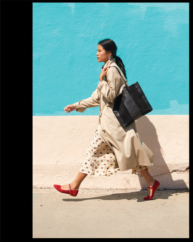 Sandra walking with the Black Suede & Nappa Bande Tote on her shoulder.
