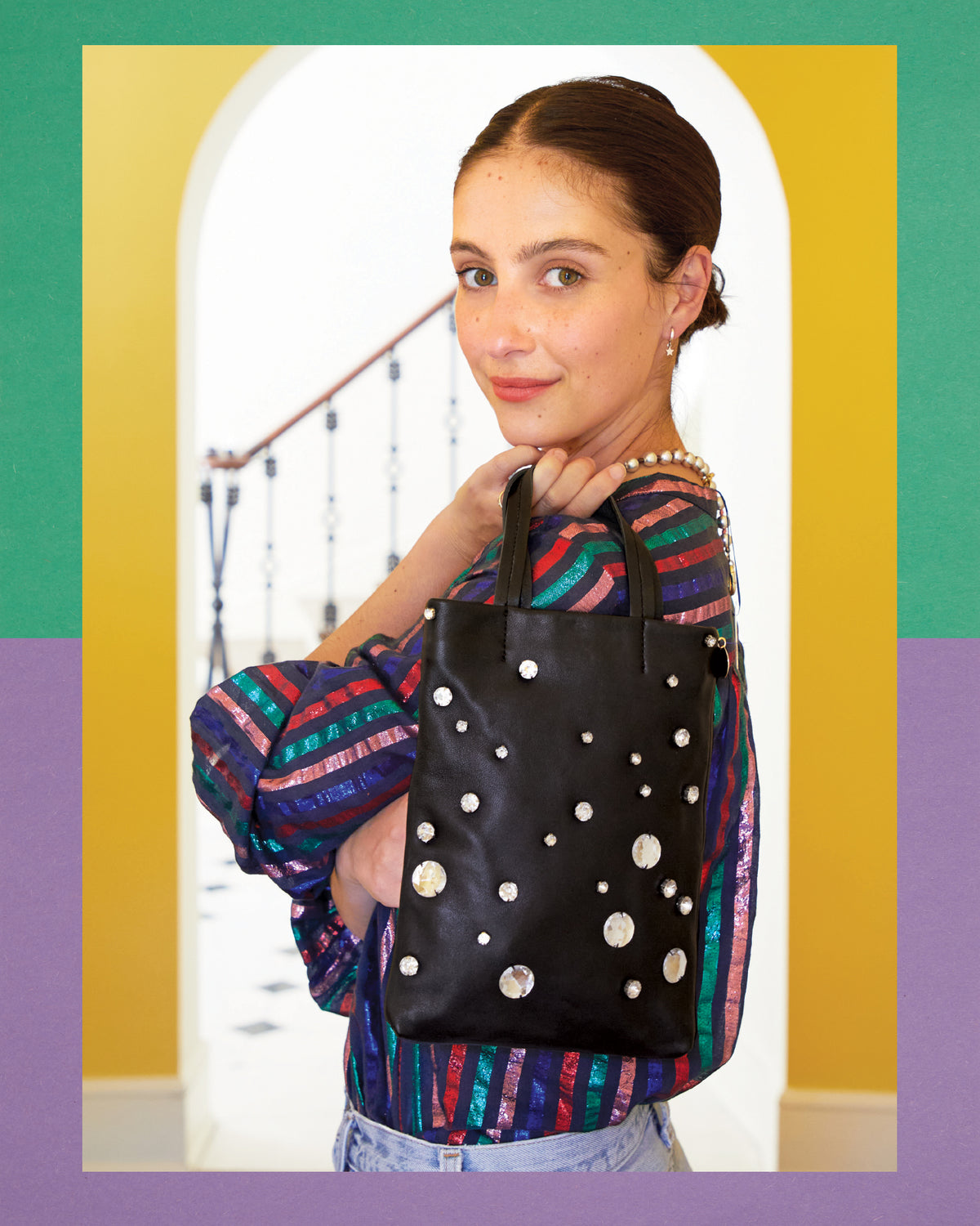 Frannie wearing the Multi Lurex Stripe Thea Blouse and carrying the Petit Mick in Black Nappa with Stones. 