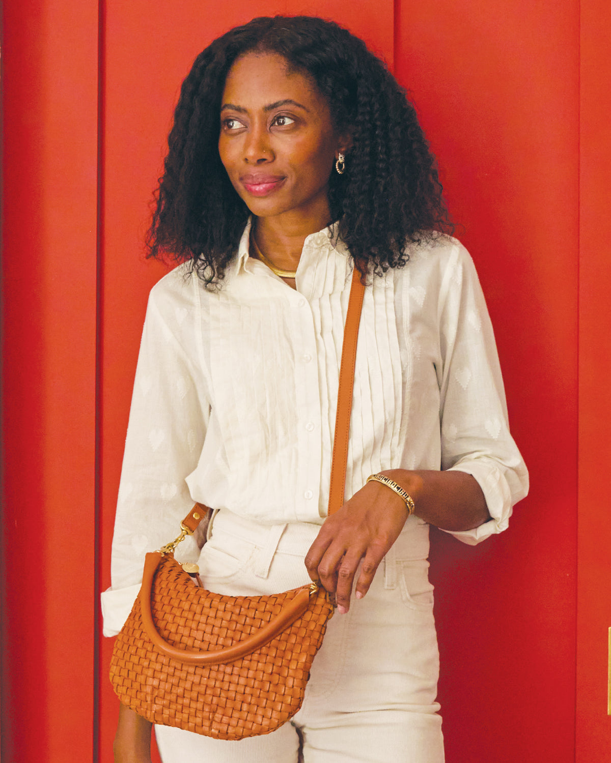 Mecca wearing the Anette Tuxedo Shirt and carrying the Petit Moyen in Natural Woven Checker as a crossbody bag. 