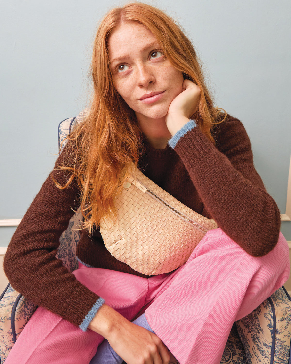 Model wearing the Cream Woven Grande Fanny Pack across her chest. 