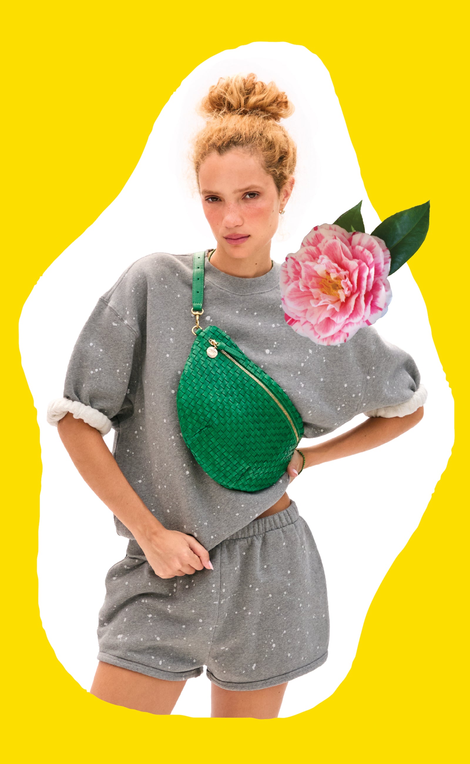 Model wearing the Grey Melange Splatter Set and carrying the Grass Woven Checker Grande Fanny across her chest. 