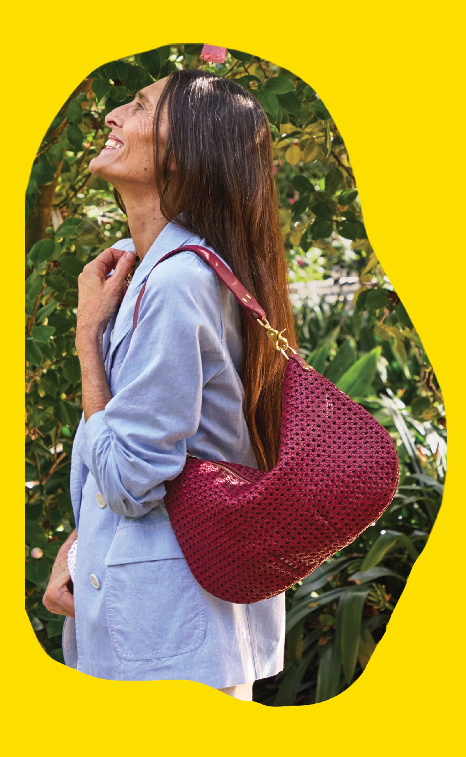 Model wearing the Light Blue Chambray Le Blazer and carrying the Plummy Rattan Moyen Messenger over her shoulder.