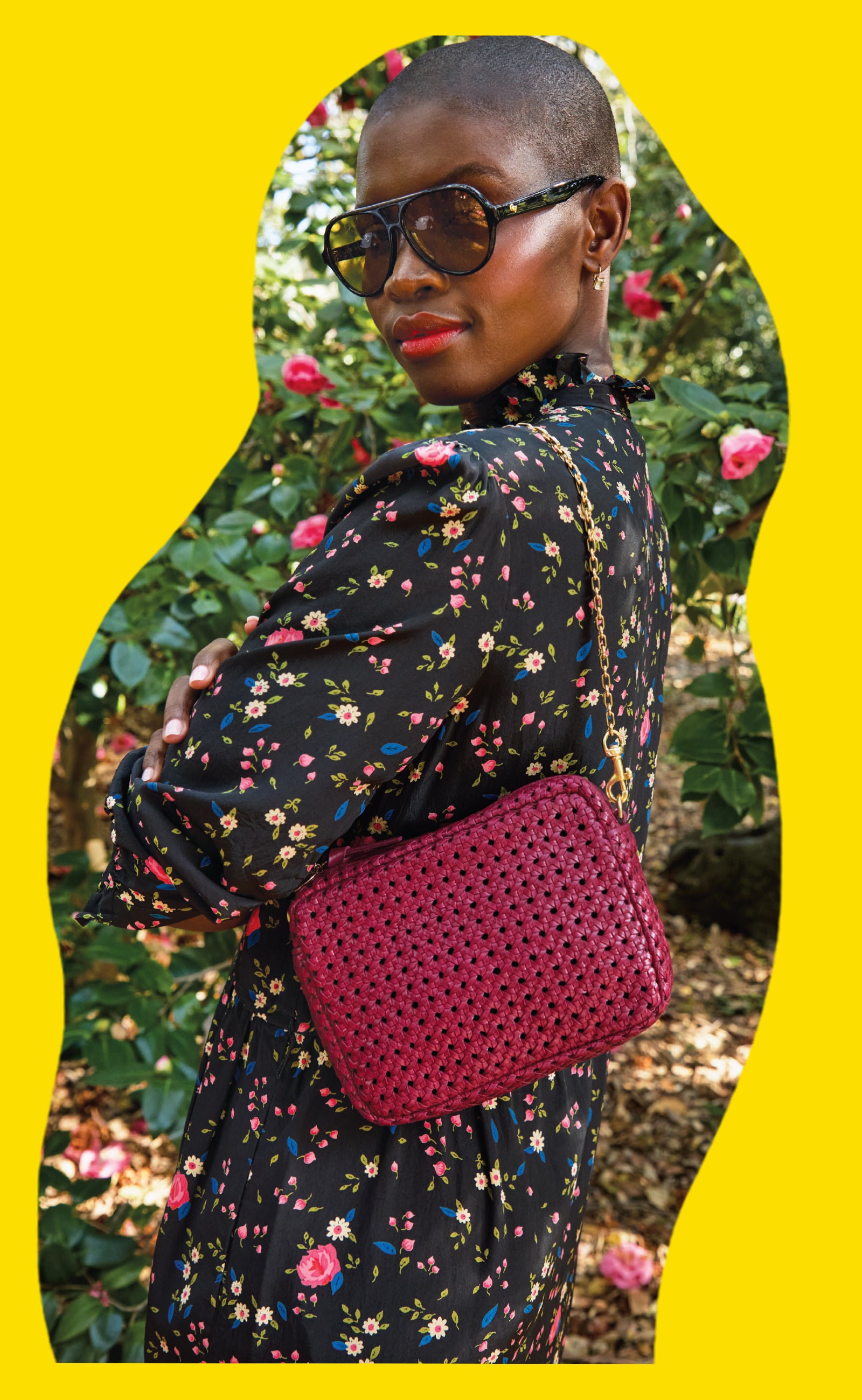 Model carrying the Plummy Rattan Midi Sac with Oval Chain Shoulder Strap. 