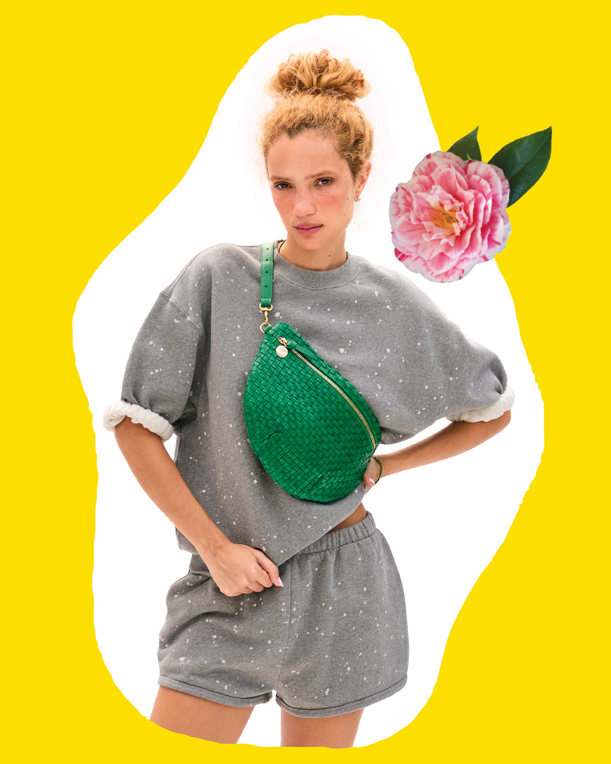 Model wearing the Grey Melange Splatter Set and carrying the Grass Woven Checker Grande Fanny across her chest. 