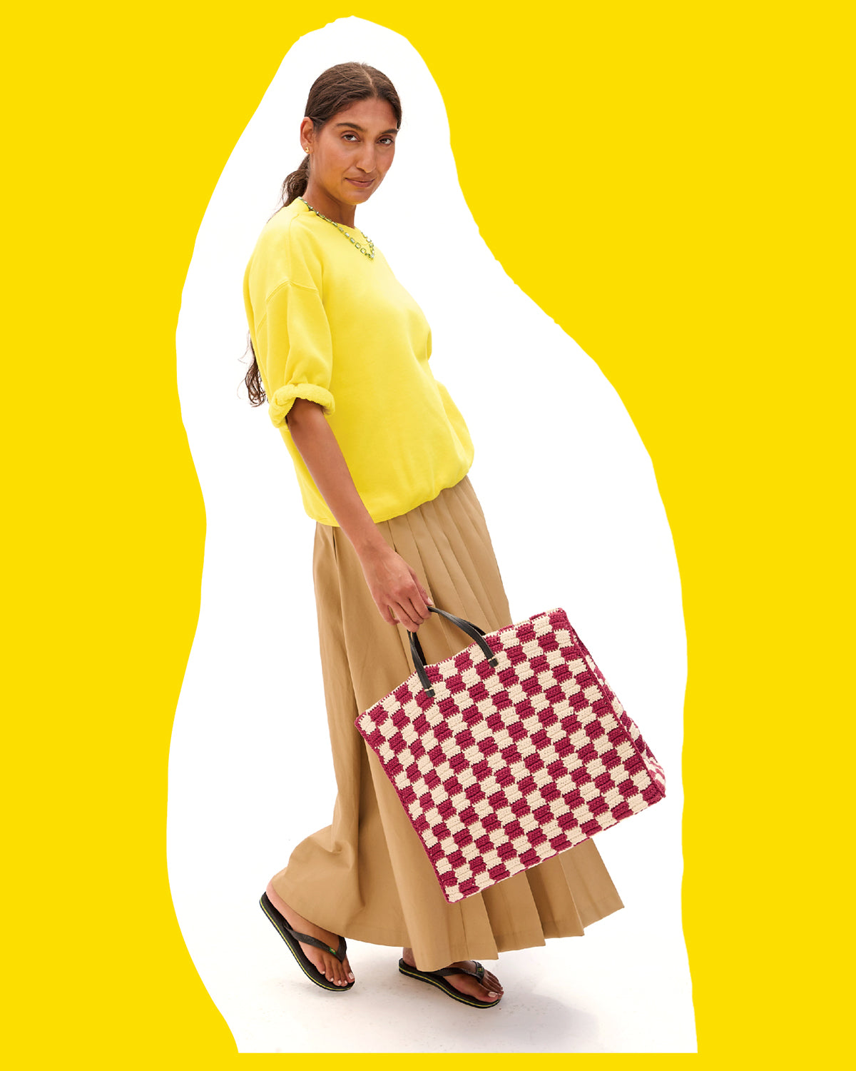 Model wearing the Citron Short Sleeve Oversized Sweatshirt and carrying the Plummy and Cream Summer Simple Tote. 