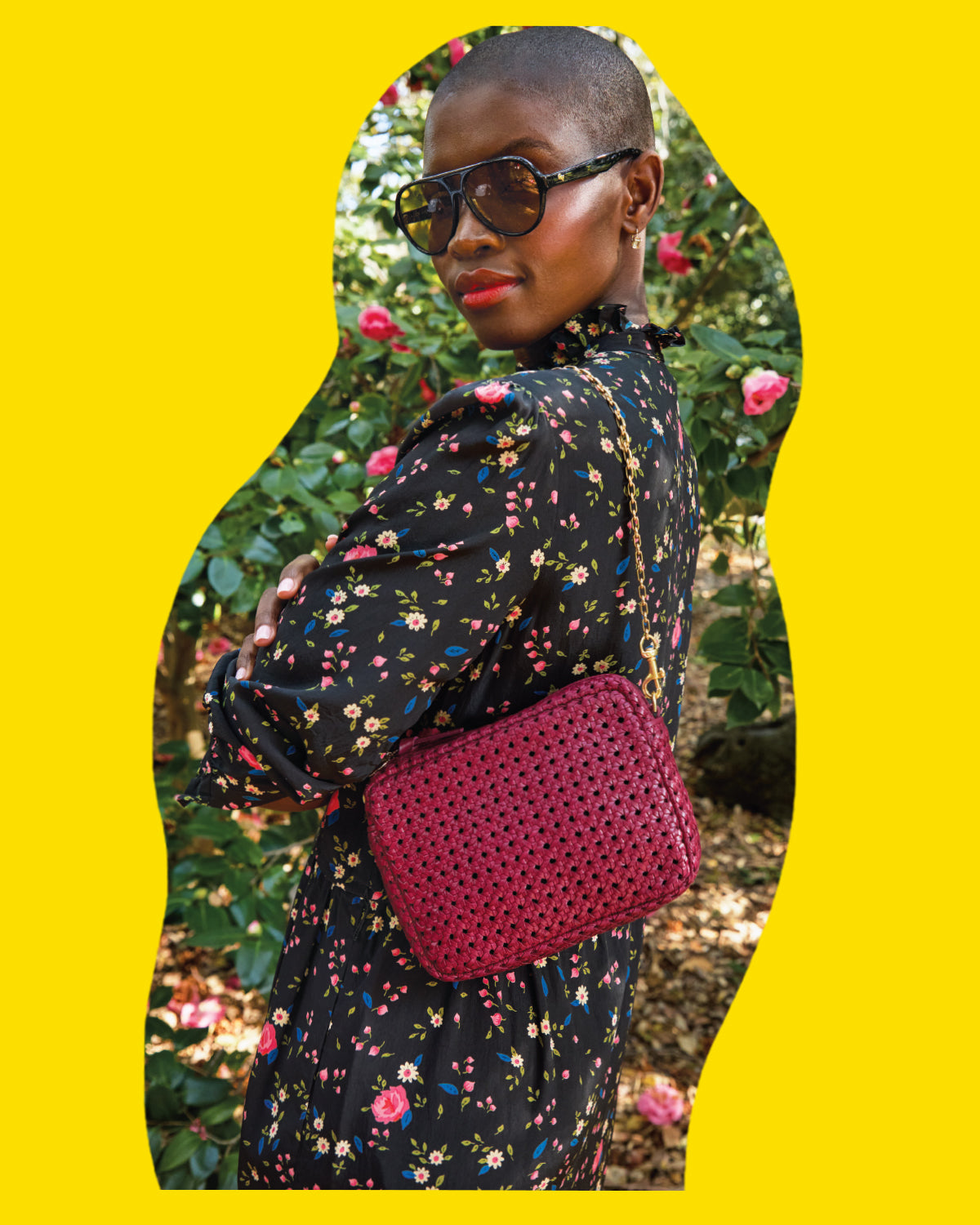 Model carrying the Plummy Rattan Midi Sac with Oval Chain Shoulder Strap. 