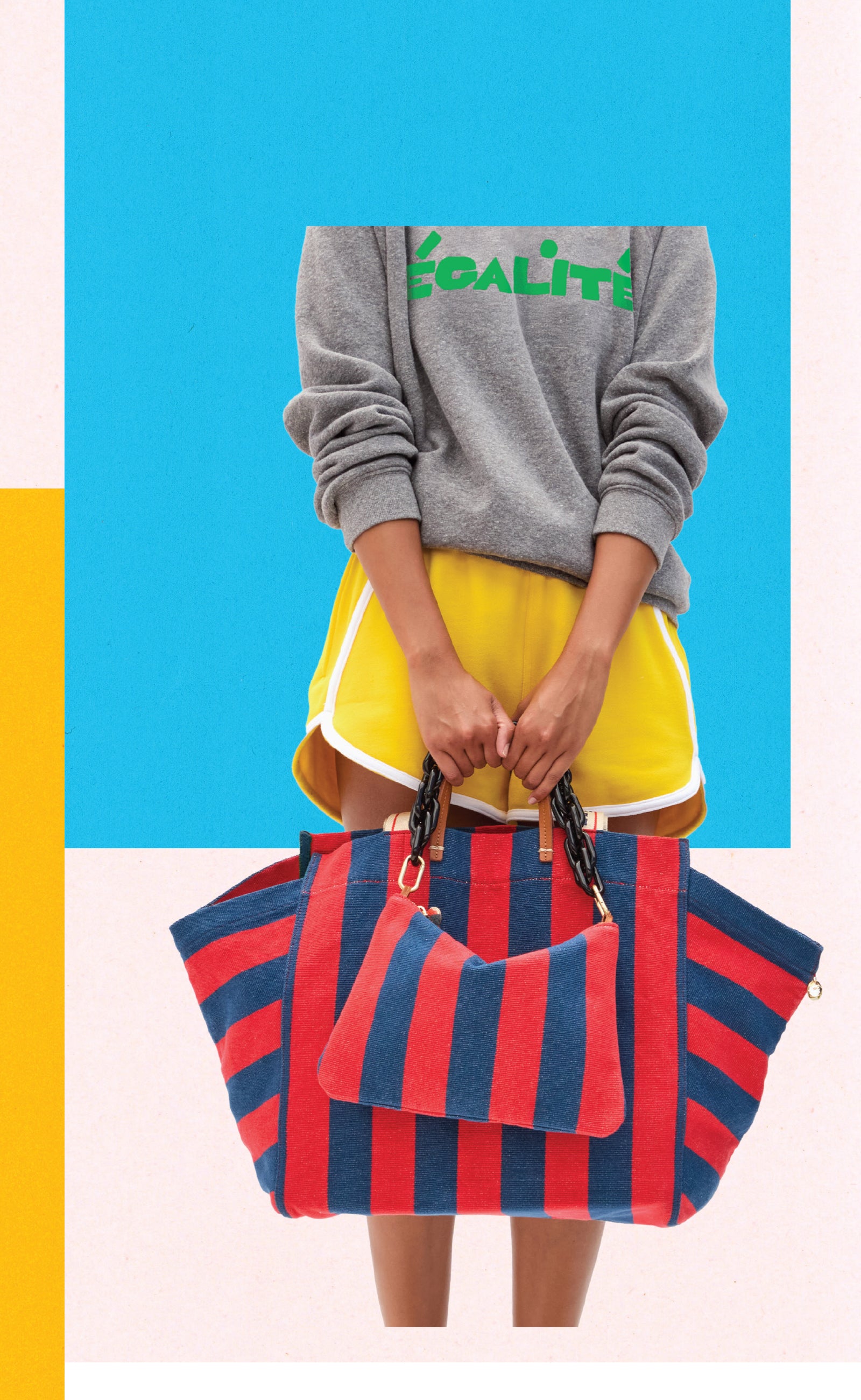 Model holding the La Côte Tote with matching Flat Clutch in Poppy and French Blue Canvas Stripe with Black Shortie Strap. 