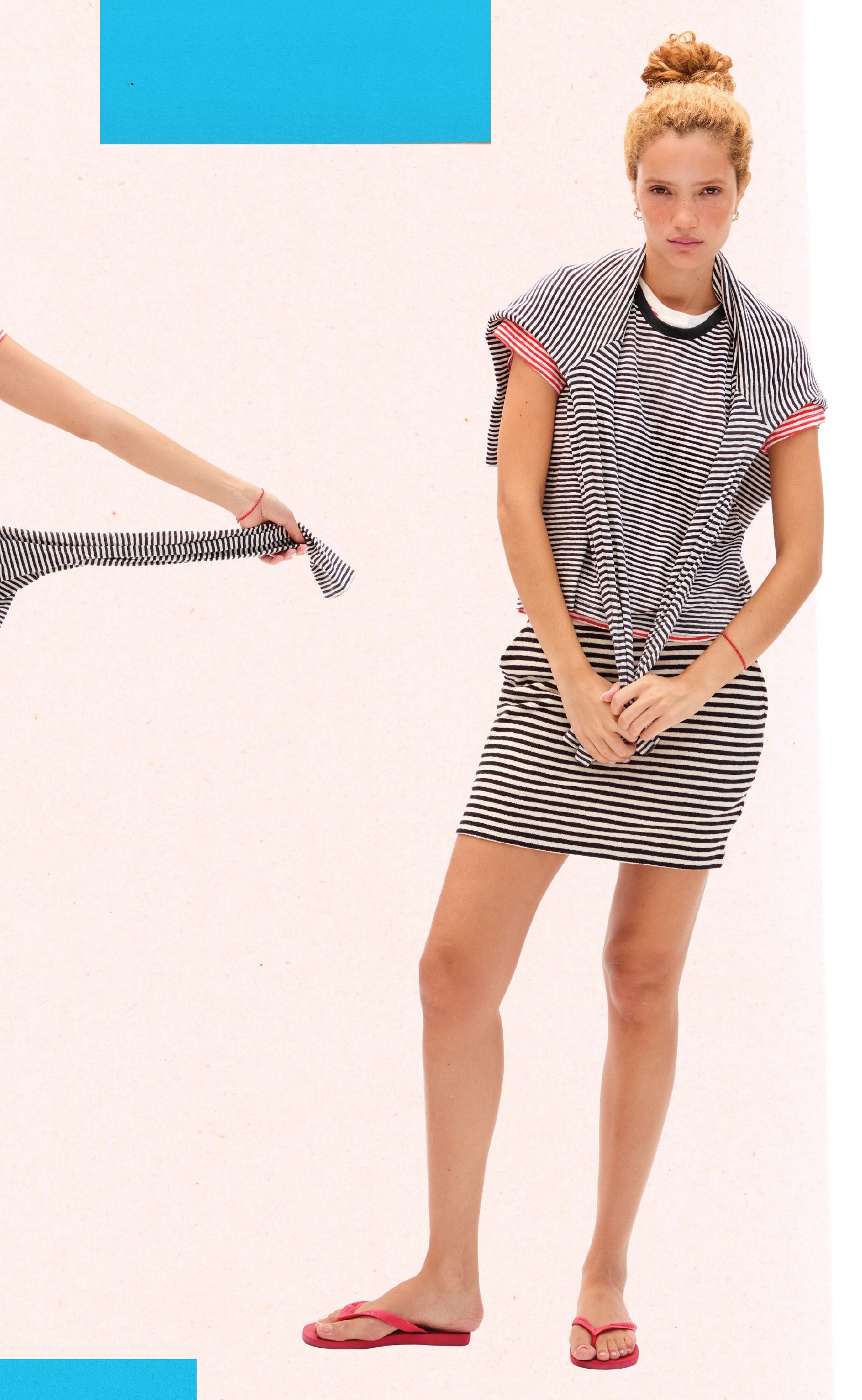 Model wearing the Black and Cream Stripe Mini Skirt, Tank Top, Long Sleeve Tee and Bright Poppy and Cream Classic Tee. 