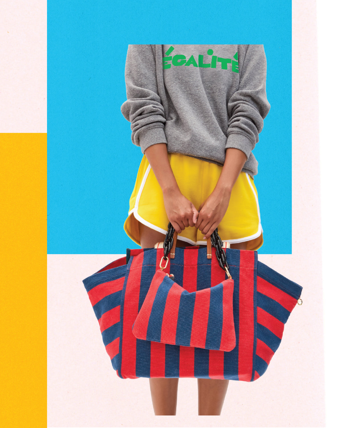 Model holding the La Côte Tote with matching Flat Clutch in Poppy and French Blue Canvas Stripe with Black Shortie Strap. 