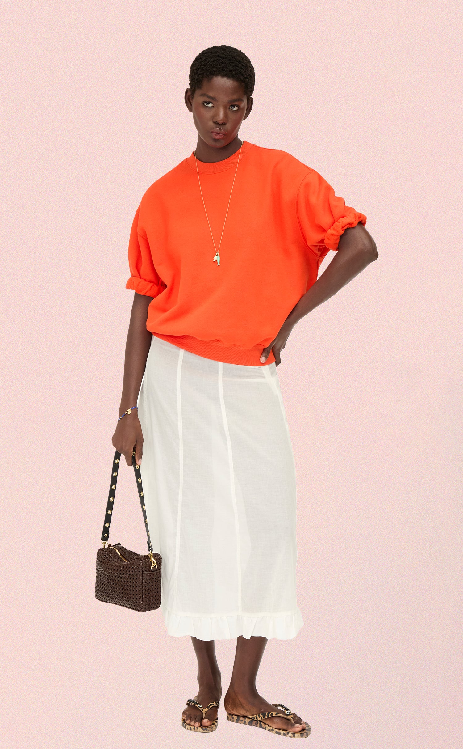 Model carrying the Chocolate Rattan Midi Sac with the Grommet Shoulder Strap. 