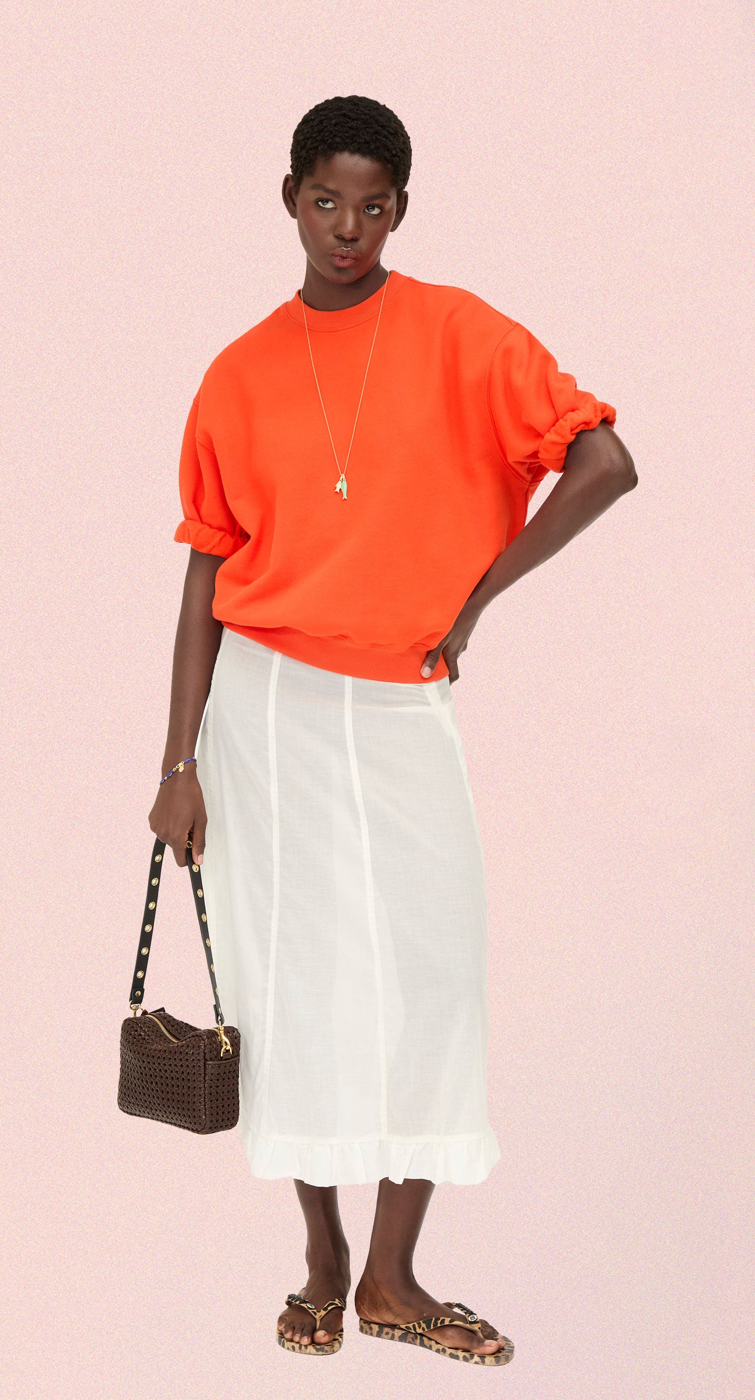 Model carrying the Chocolate Rattan Midi Sac with the Grommet Shoulder Strap. 