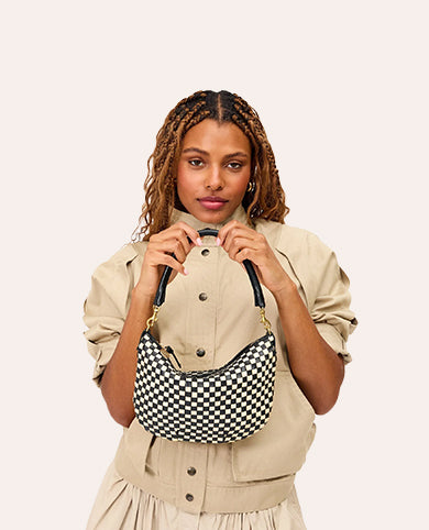 Model carrying the Black/Cream Checker Petit Moyen. 