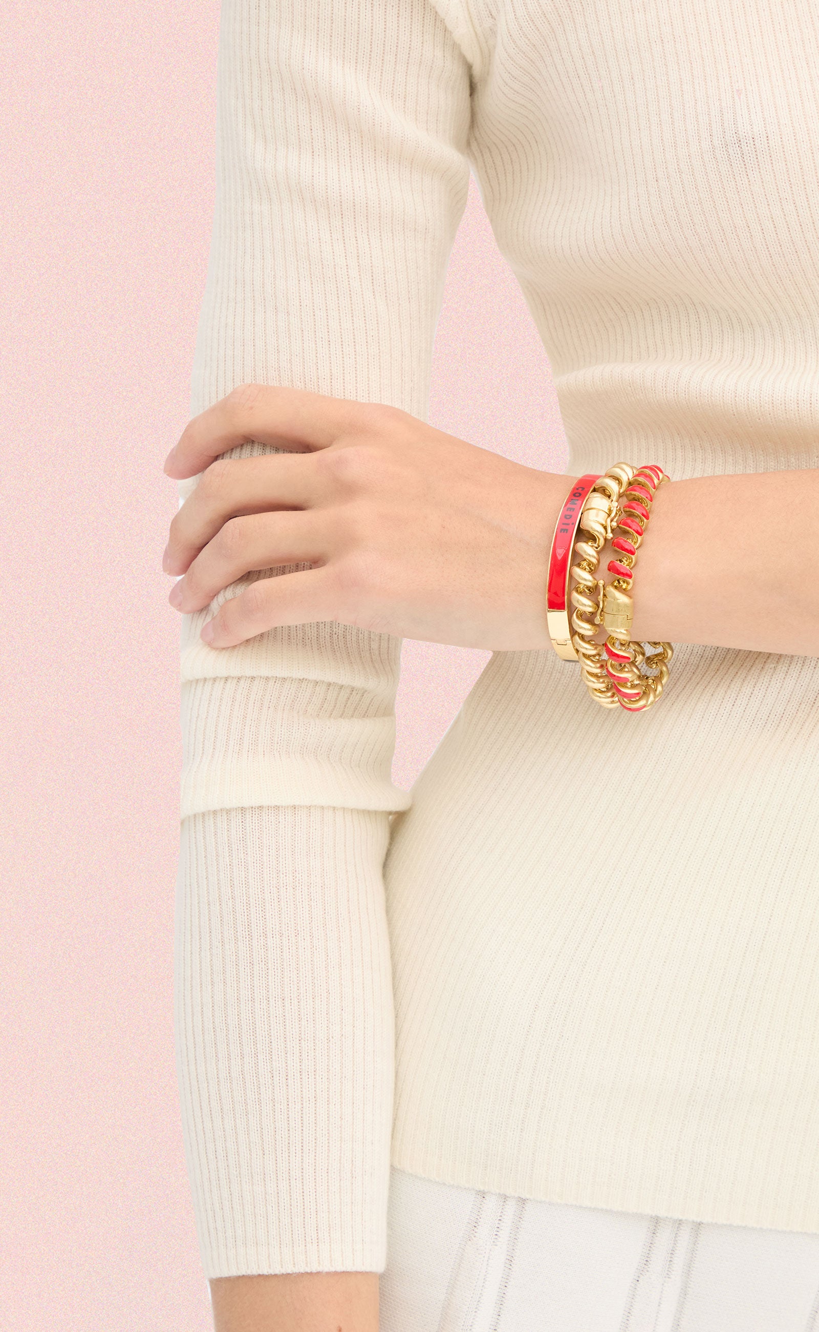 Model wearing a stack of three Clare V. bracelets. 