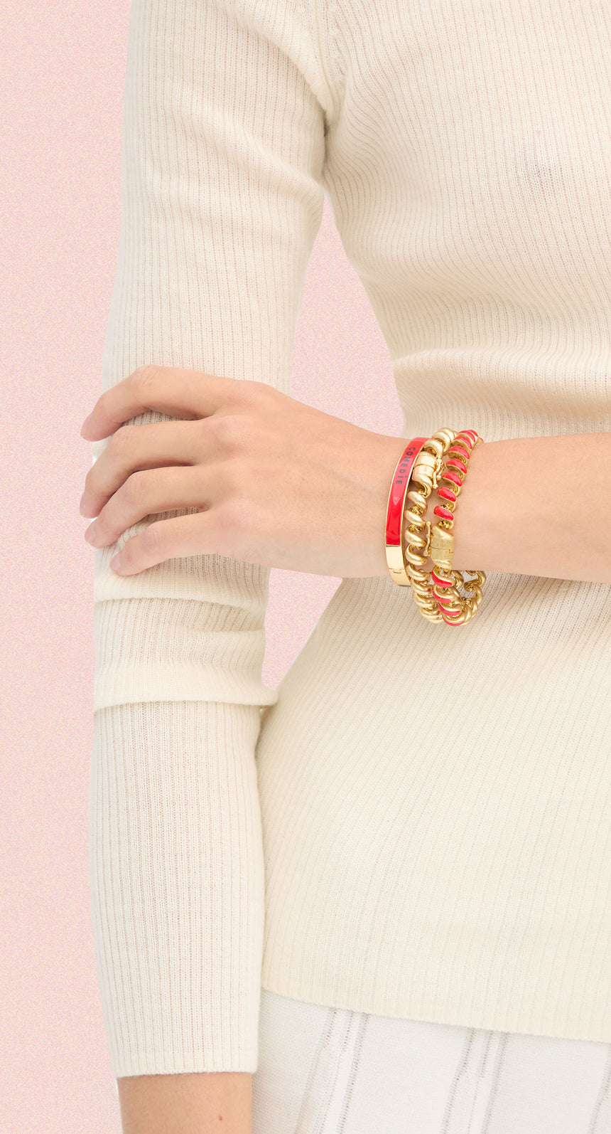 Model wearing a stack of three Clare V. bracelets. 