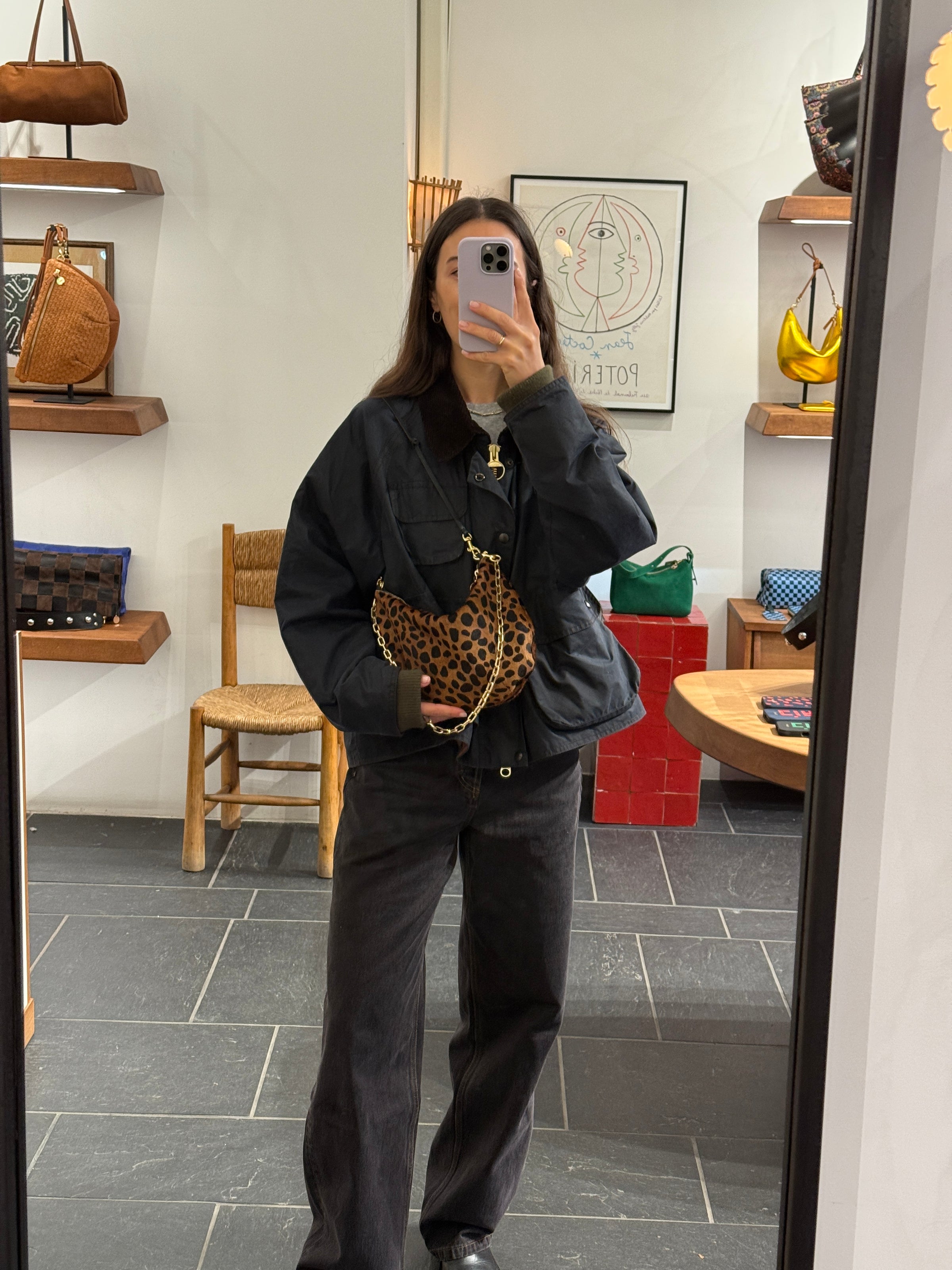 Model carrying the Leopard Lune with Oval Chain Shoulder Strap.